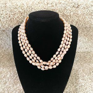 Light pink genuine pearl necklace on a continuous very long strand.